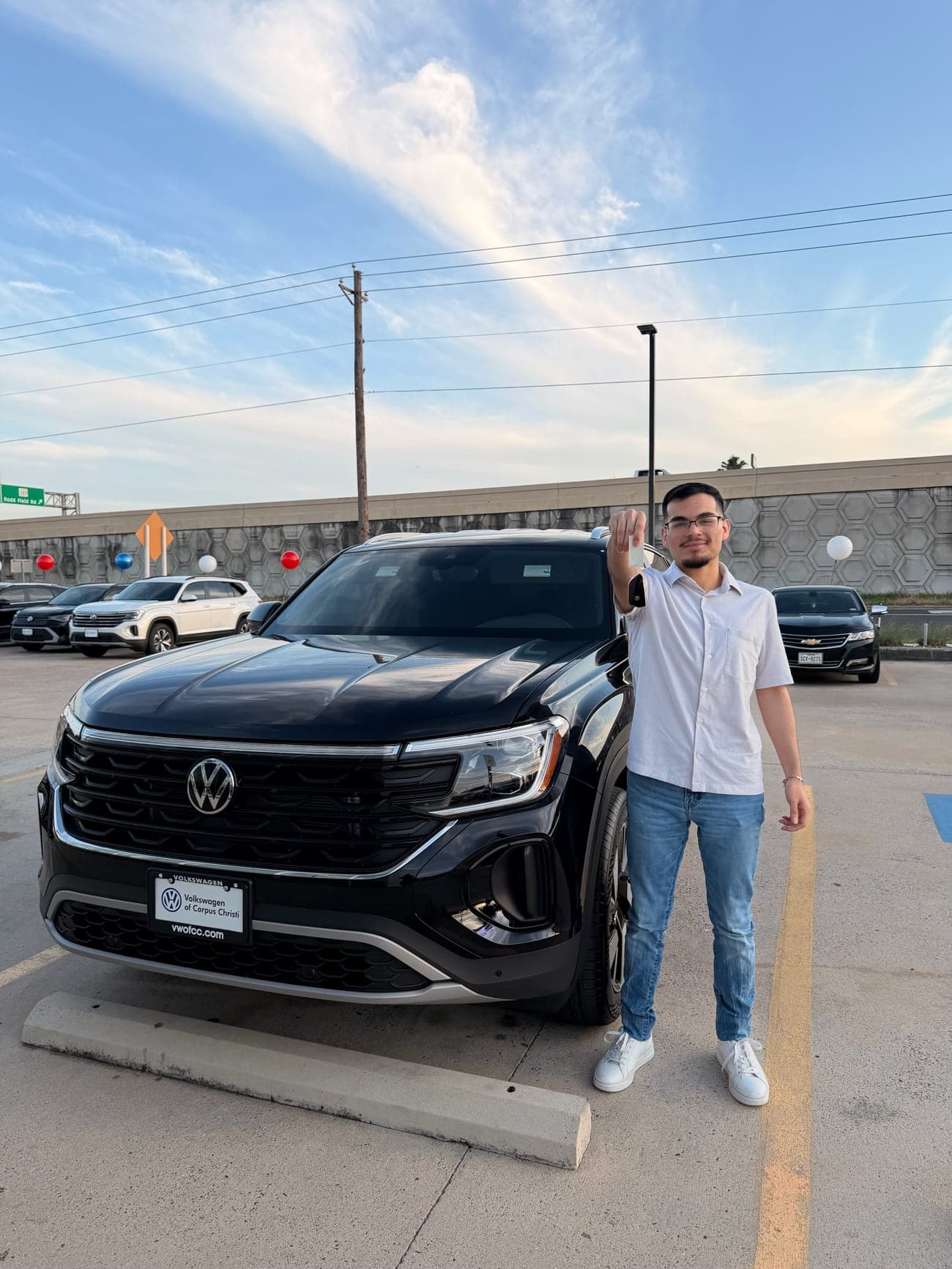 Andy, a Credit Repair Masterclass student, next to the car he was approved for